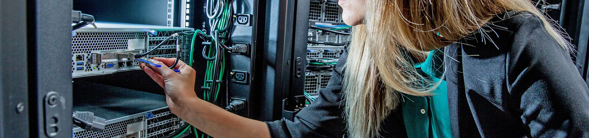 Female IT Engineer Working in Server Room.